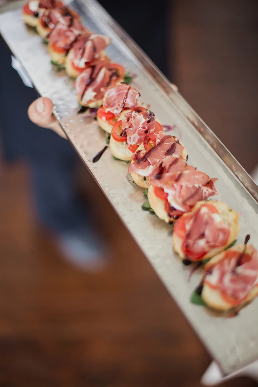 Passed crostini appetizers with prosciutto and balsamic glaze